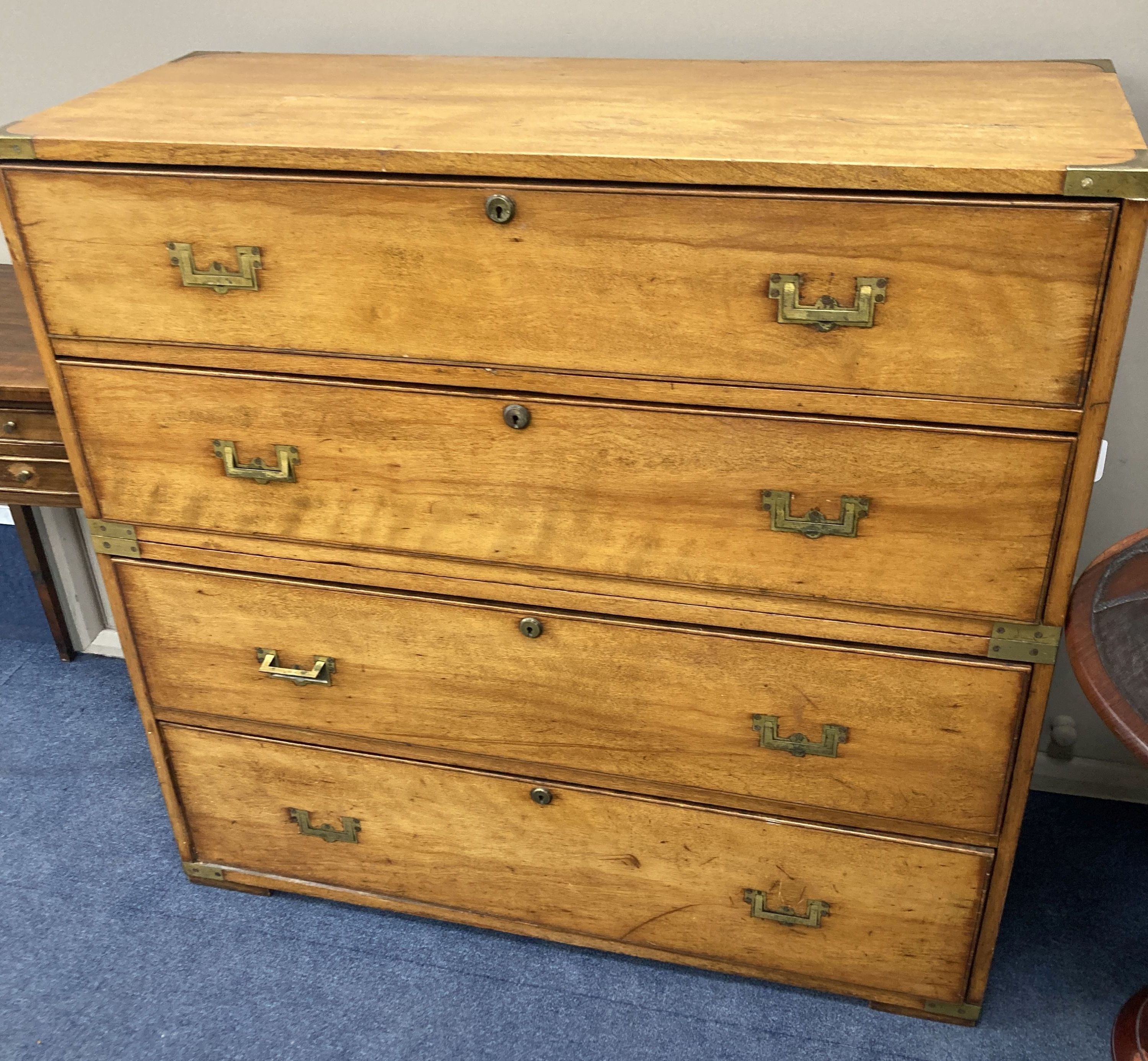 A 19th century two sectional fruitwood campaign chest, of four long drawers, brass capped with flush fitting handles and further carryi